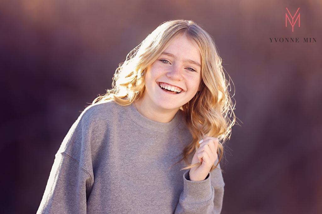 A family portrait of a teen girl taken in natural light in Thornton, Colorado.