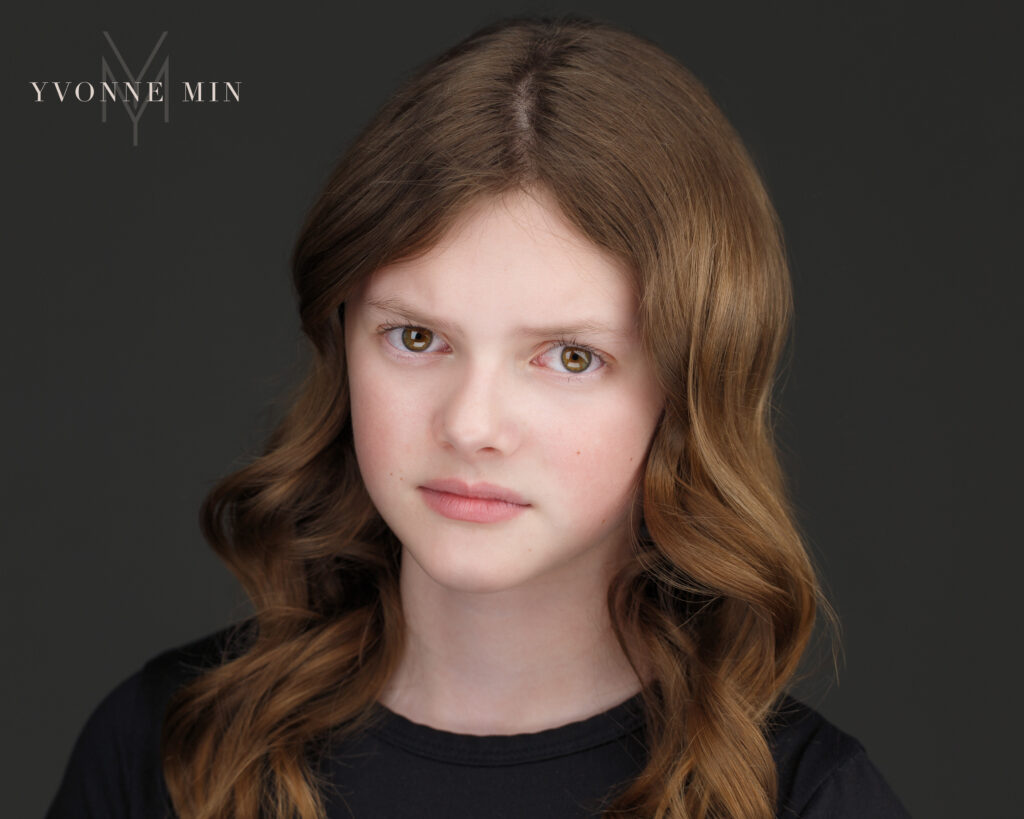 Young actress portrays a "mean girl" expression in one of her headshots by Yvonne Min Photography.