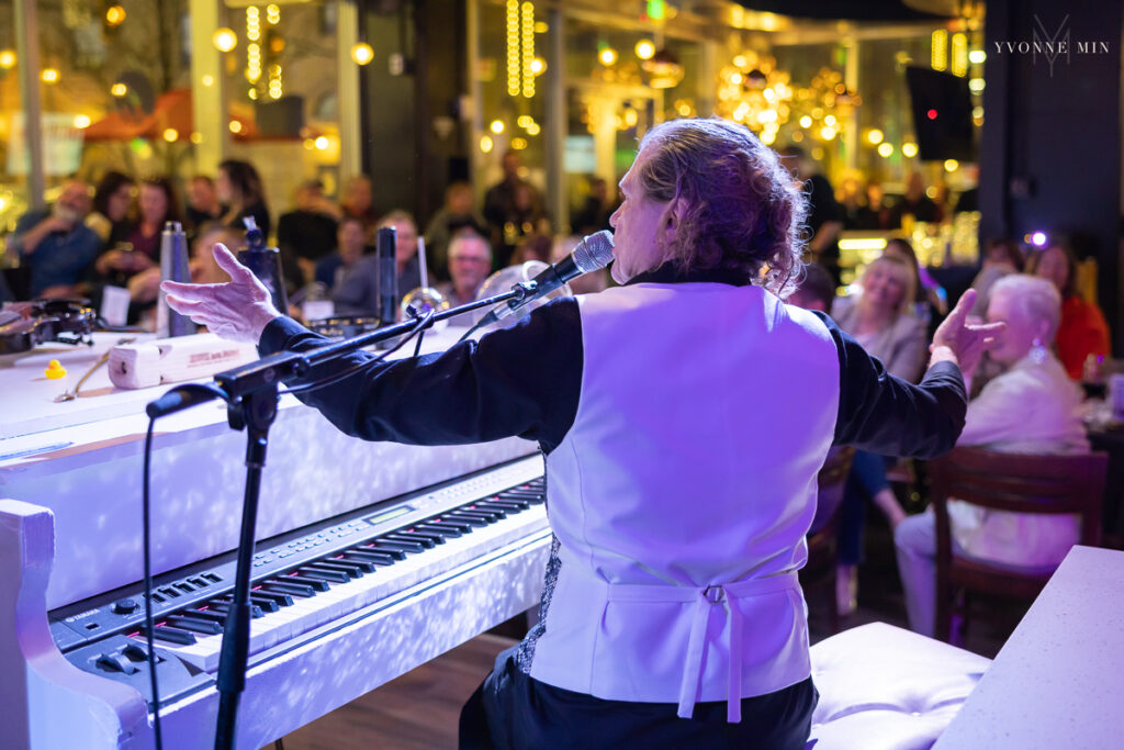 Image of a piano player in front of a crowd at Fortissimo Dueling Pianos in downtown Denver, Colorado.