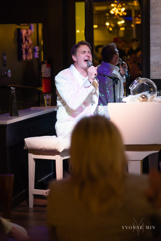 A male piano player entertains the crowd at Fortissimo Dueling Pianos in downtown Denver, Colorado.