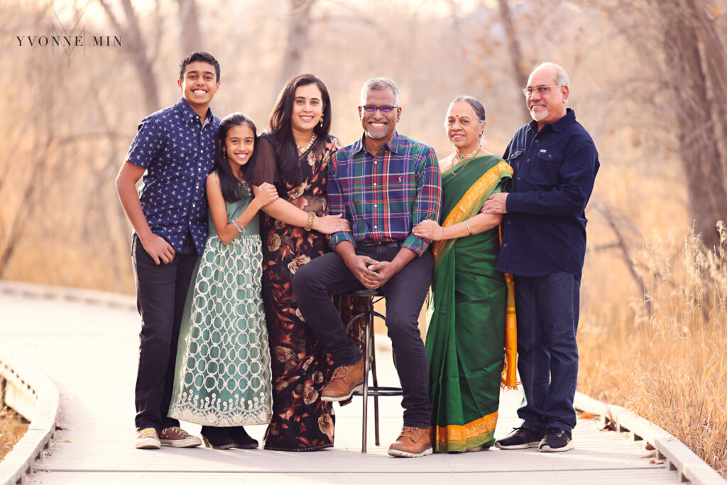 Indian family with saris standing together on a bridge in Thornton, Colorado.