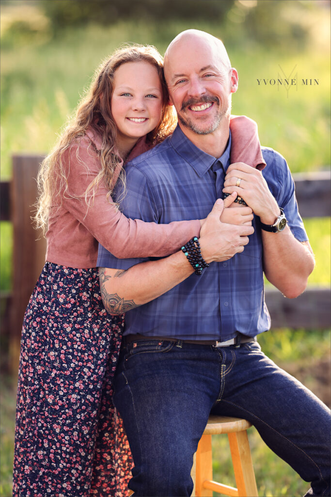 A dad and daughter hug at McKay Lake during their family photoshoot with Yvonne Min Photography in Westminster, Colorado.