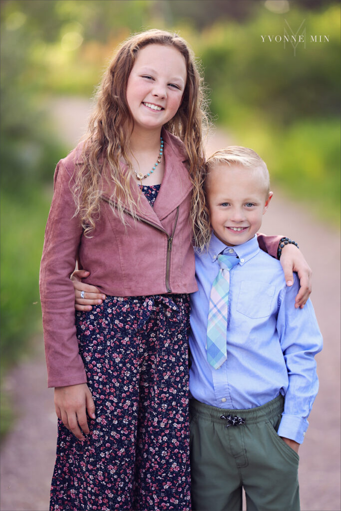 A photograph of an older sister and her little brother taken at McKay Lake in Westminster, Colorado by Yvonne Min Photography.