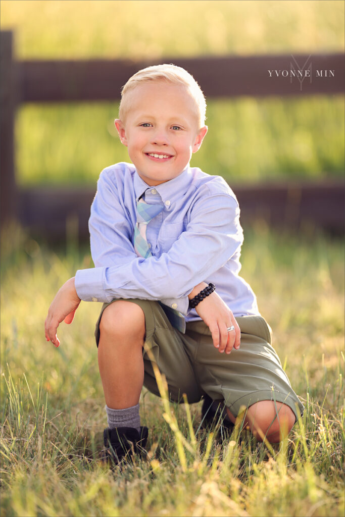 A photograph of a young boy in a tie taken at McKay Lake in Westminster, Colorado by Yvonne Min Photography.