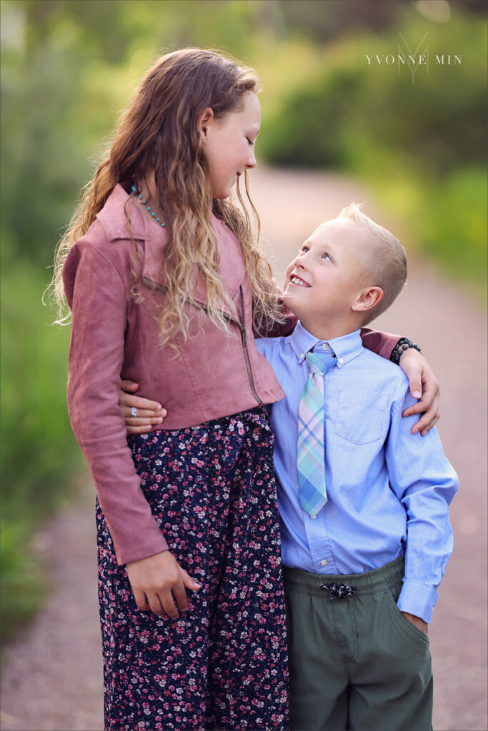 A photograph of an older sister and her little brother taken at McKay Lake in Westminster, Colorado by Yvonne Min Photography.