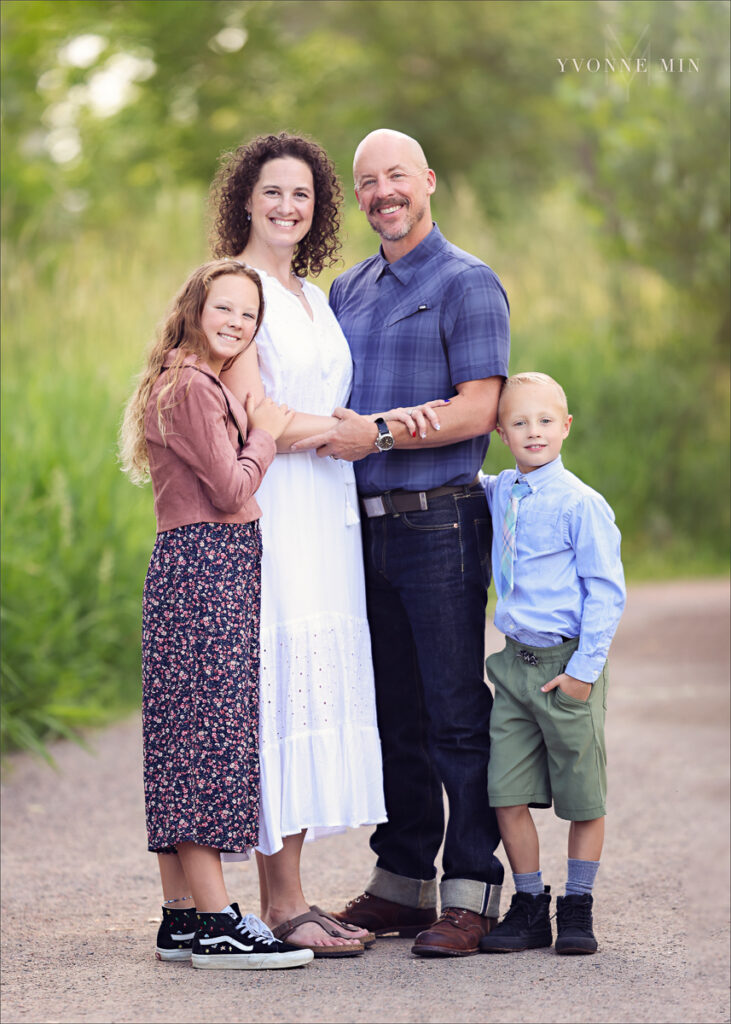 A photograph of a family hugging on a trail at McKay Lake in Westminster, Colorado with Yvonne Min Photography.
