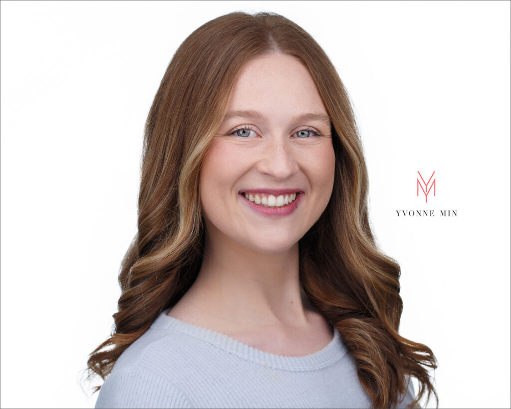 A headshot of a young behavioral therapist on a white background photographed by Yvonne Min Photography in Thornton, Colorado.