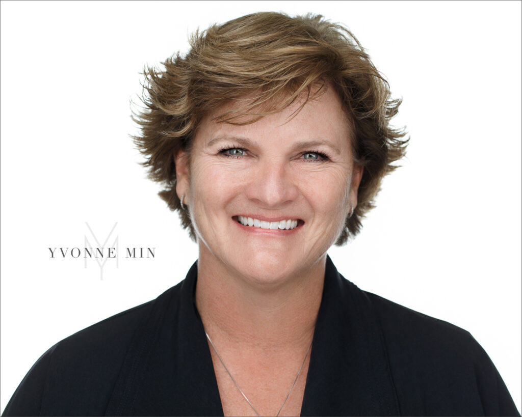 A headshot of a woman on a white background taken in the studio of Yvonne Min Photography in Thornton, Colorado.