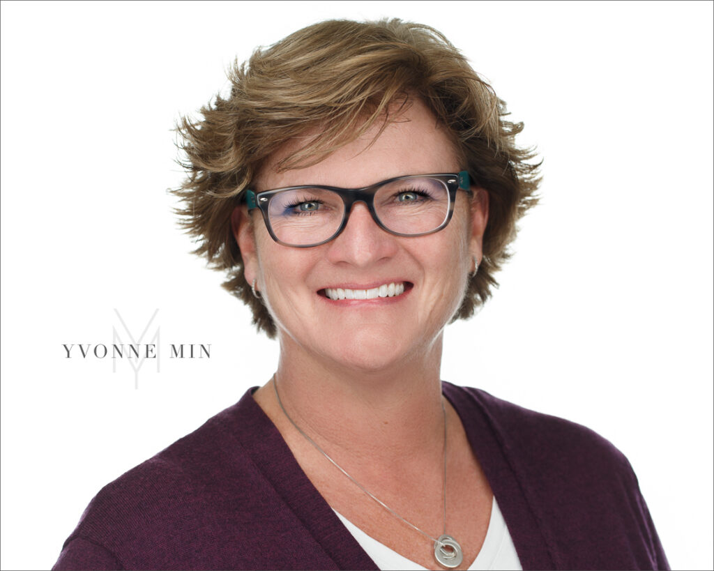 A headshot of a woman on a white background taken in the studio of Yvonne Min Photography in Thornton, Colorado.