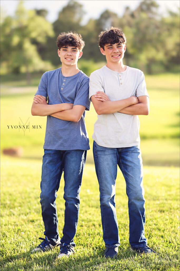 Two twin teenage brothers pose together at their family photography session with Yvonne Min Photography at Purple Park, Superior, Colorado.