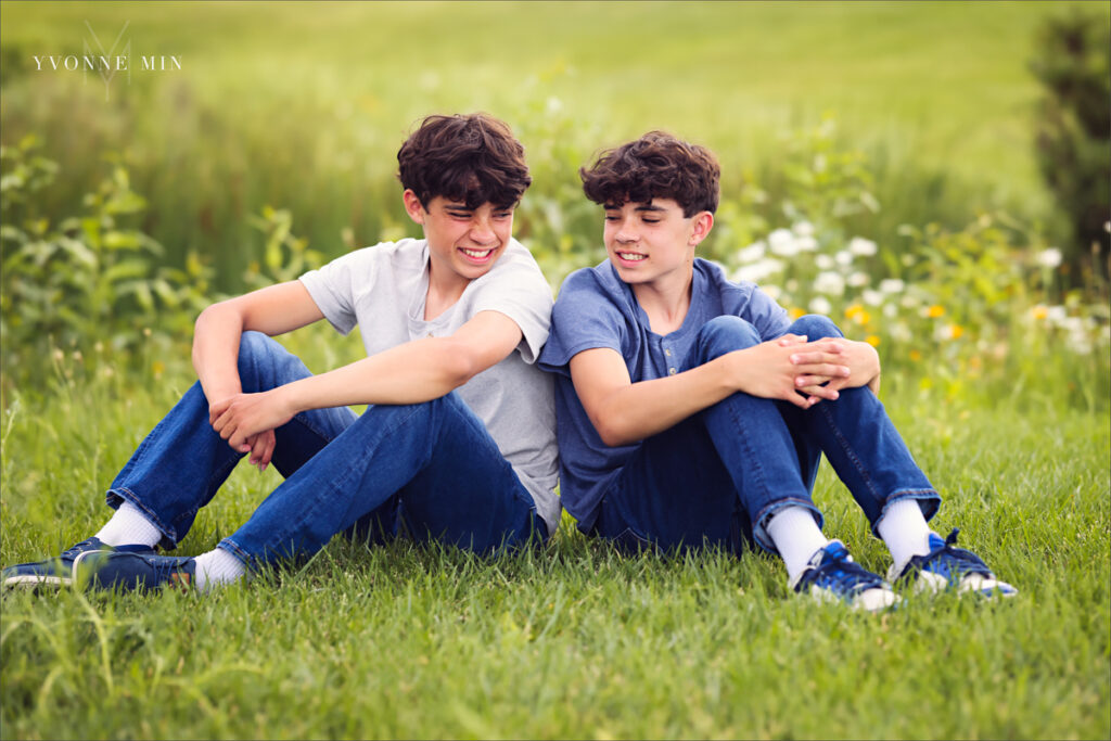 Two twin teenage brothers pose together at their family photography session with Yvonne Min Photography at Purple Park, Superior, Colorado.
