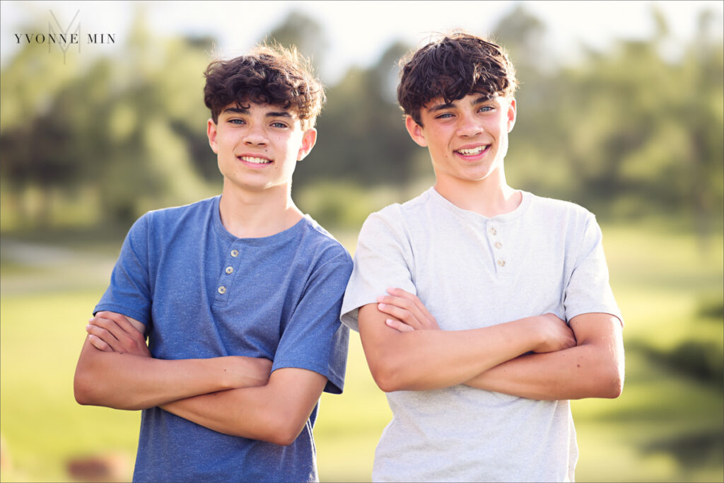 Two twin teenage brothers pose together at their family photography session with Yvonne Min Photography at Purple Park, Superior, Colorado.