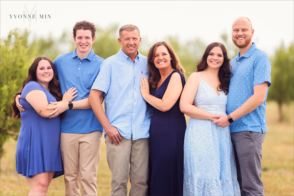 A photograph of a family in the apple orchards of Wild Cider in Longmont, Colorado taken by Yvonne Min Photography.