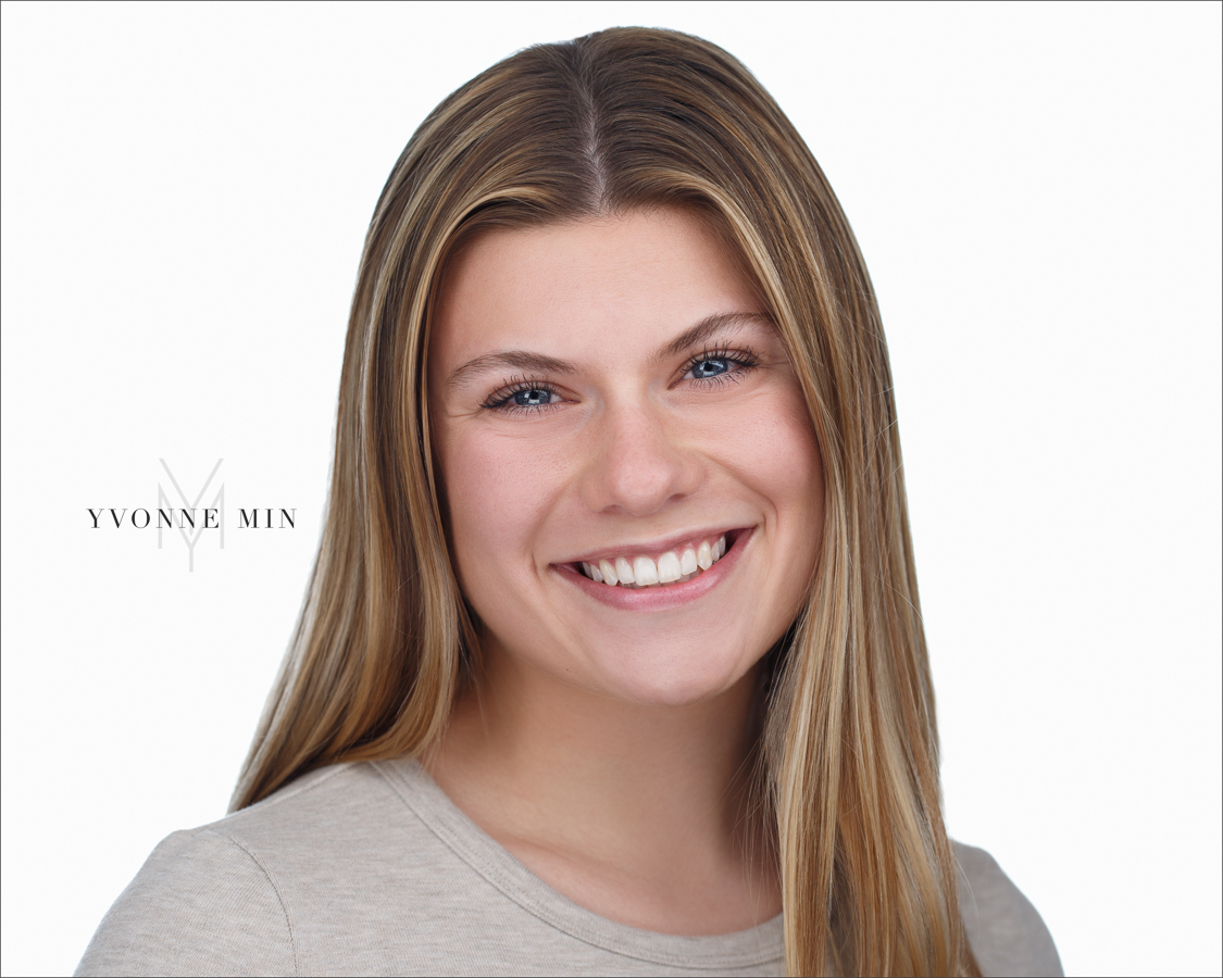 Headshot of a young woman on a white background taken in the studio of Yvonne Min Photography in Thornton, Colorado.