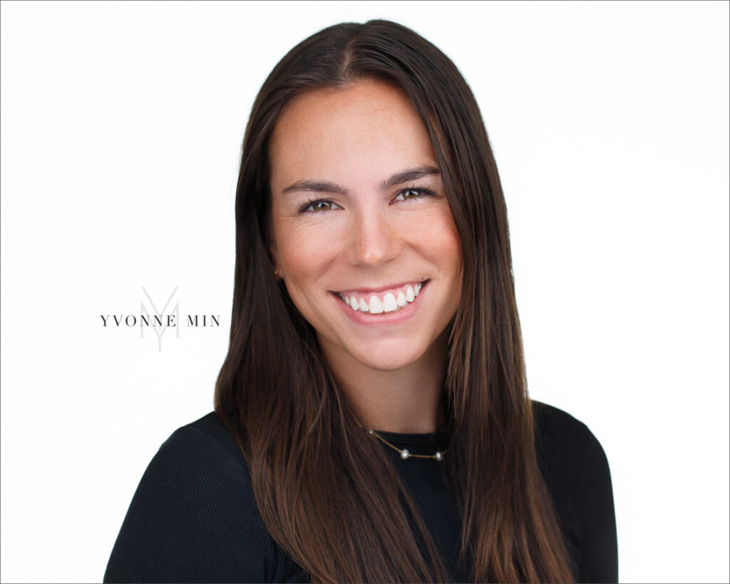 A headshot of a young woman in black shirt taken with a white background at Yvonne Min Photography in Thornton, Colorado.