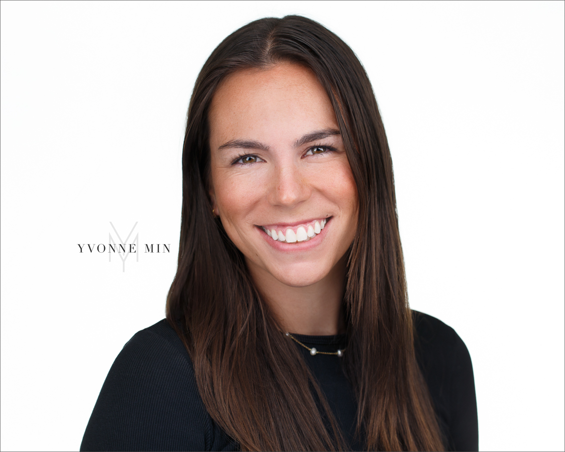 A headshot of a woman on a white backdrop taken in the studio of Yvonne Min Photography in Thornton, Colorado.