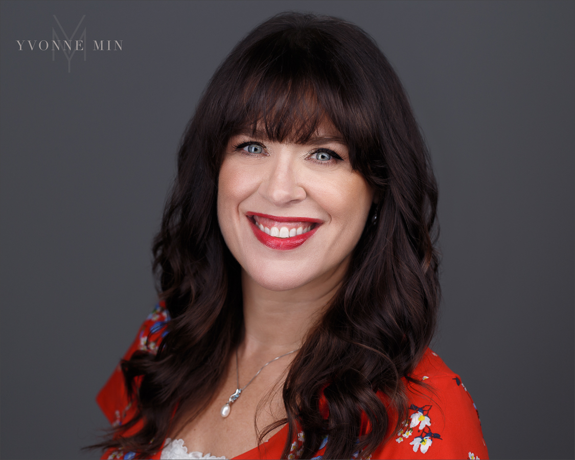 A new headshot for a therapist in Boulder taken on a dark gray backdrop in Thornton, Colorado by Yvonne Min Photography.