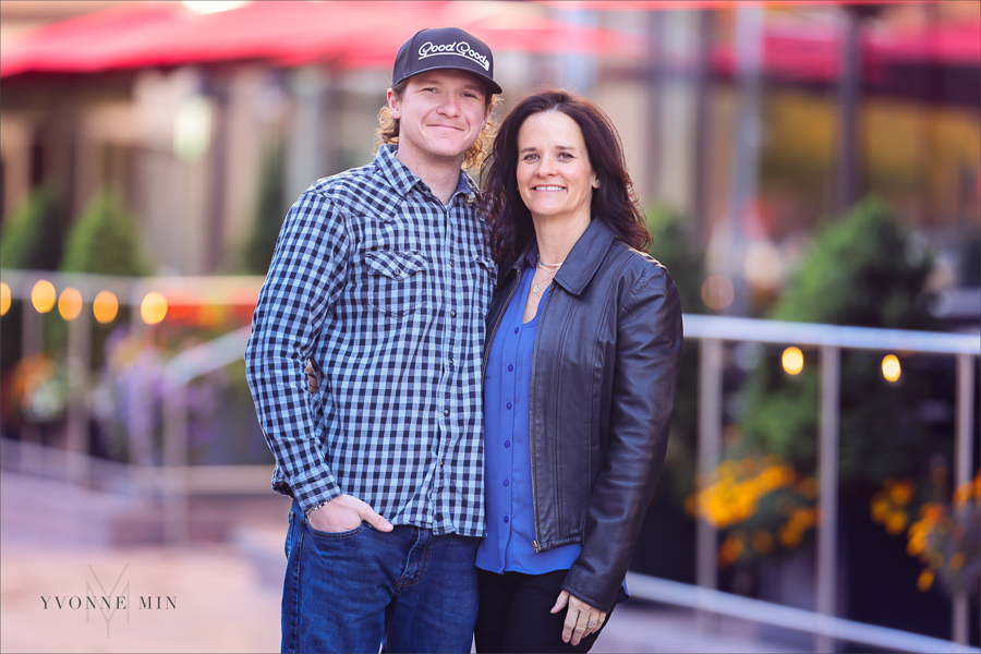 A mom and her adult son pose for Yvonne Min Photography outside Union Station in downtown Denver.