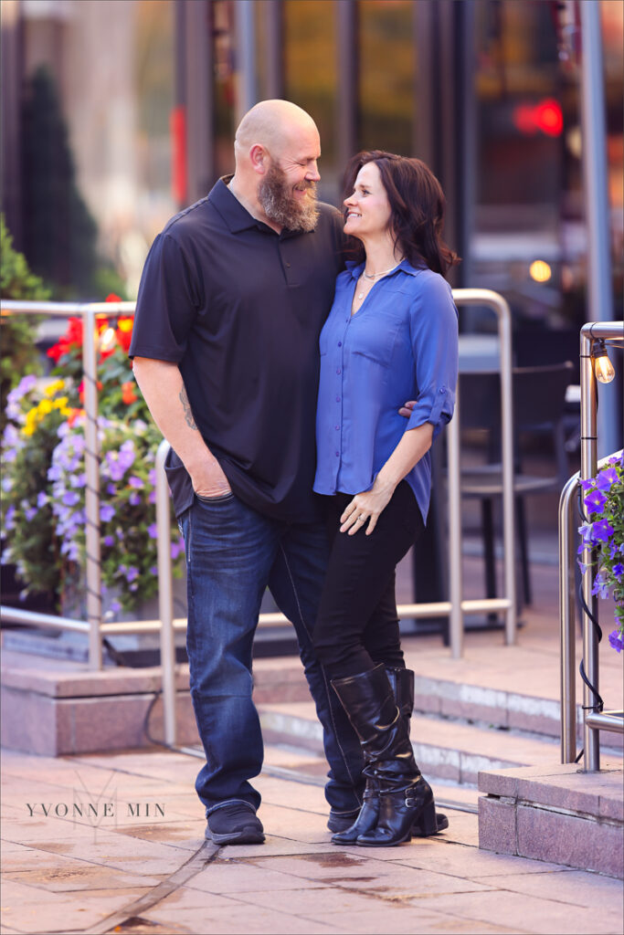 A mom and dad walking together taken outside of Union Station in downtown Denver by Yvonne Min Photography.