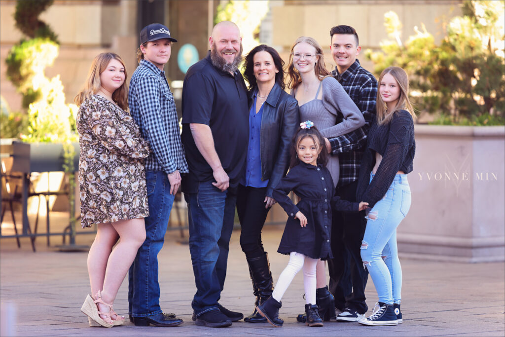 A family photograph
 with eight people taken outside Union Station in downtown Denver by Yvonne Min Photography.