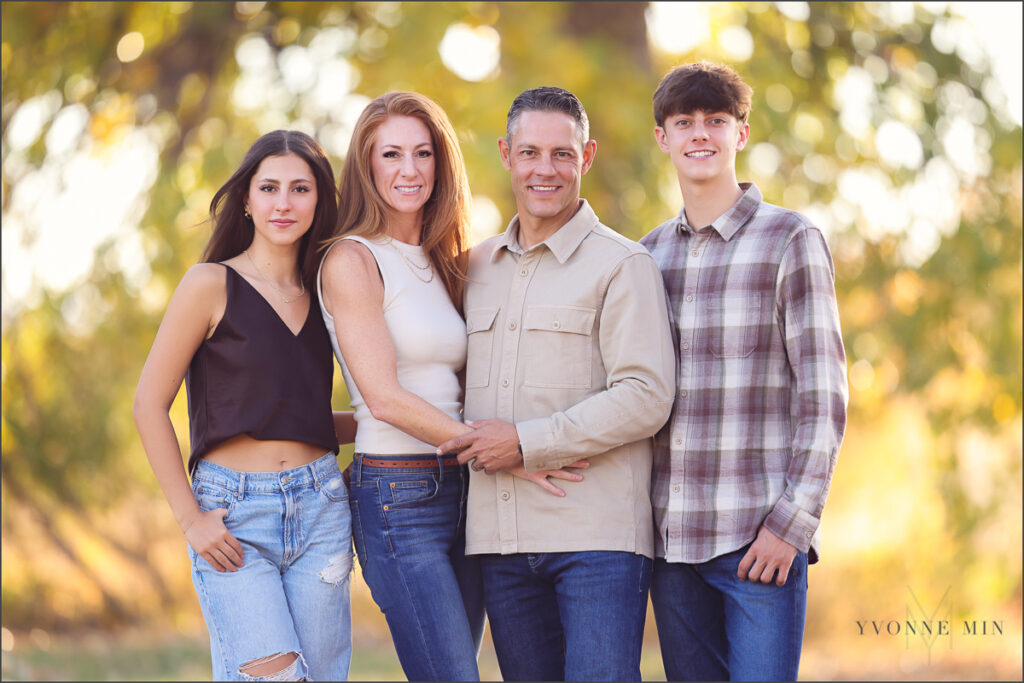 A family poses together during their family photoshoot with Yvonne Min Photography in Thornton, Colorado.