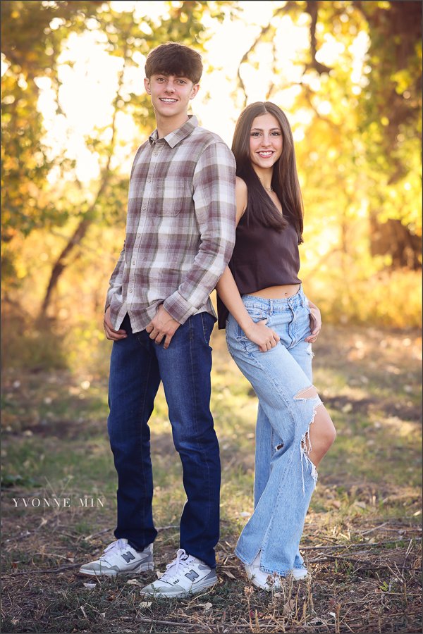 A family photograph of a brother and sister smiling together with Yvonne Min Photography in Thornton, Colorado.