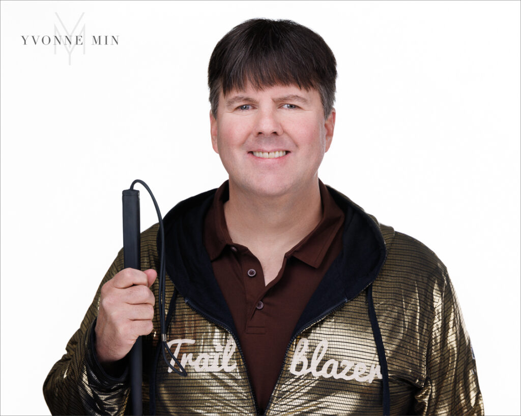 A headshot of the founder of the Blind Institute of Technology taken at the Yvonne Min Photography Studio in Thornton, Colorado on a white backdrop.